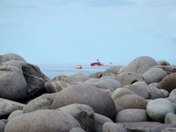 View of rocks on beach against sky