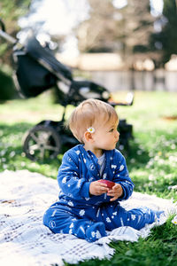 Boy sitting on field