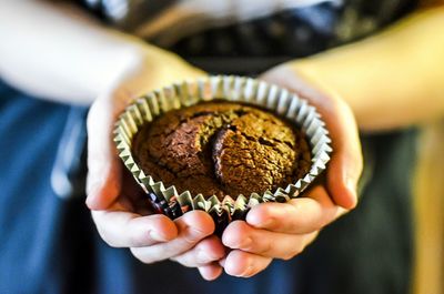Cropped image of hand holding tattoo