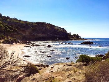 Scenic view of sea against clear blue sky