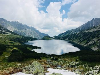 Scenic view of lake amidst mountains against sky