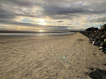 Scenic view of beach against sky during sunset