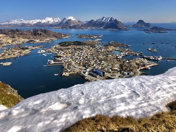 Scenic view of sea by mountains against sky