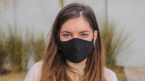 Portrait of beautiful young woman covering face