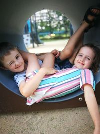 Portrait of cute smiling siblings at playground