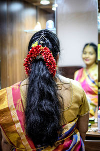 Rear view of woman with arms raised