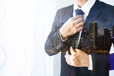 Double exposure image of businessman with buildings in city