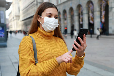 Beautiful woman wearing mask talking on video call