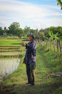Full length of man standing in field