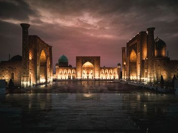 Illuminated buildings against sky at night