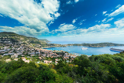 Panoramic view of city by sea against sky