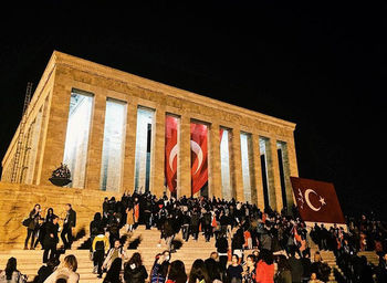 Group of people in front of building at night