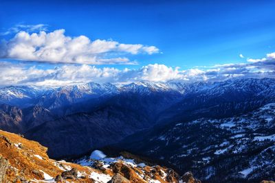 Scenic view of snowcapped mountains against sky