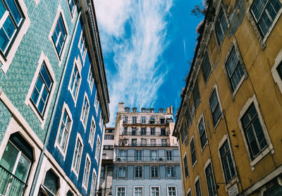 Low angle view of buildings in town against sky