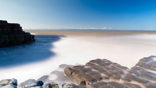 Scenic view of sea against blue sky. long exposure.