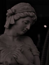 Portrait of boy statue against black background