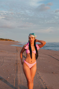 Portrait of young woman wearing bikini at beach