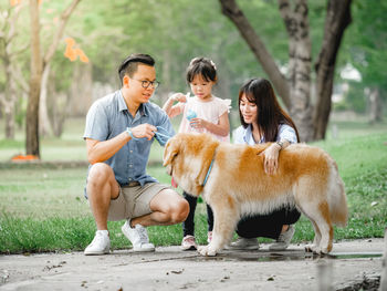 Family with dog at park