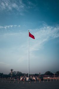 Flags on beach against blue sky