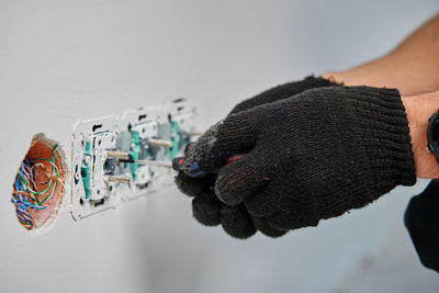 Cropped hand of person wearing hat