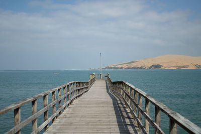 Pier over sea against sky
