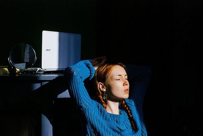 Woman sitting on seat at home