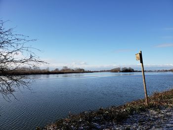 Scenic view of lake against blue sky