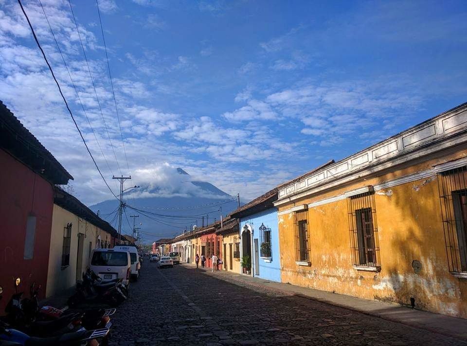 building exterior, architecture, built structure, transportation, cloud - sky, city, sky, mode of transportation, land vehicle, building, nature, street, motor vehicle, car, residential district, day, no people, road, house, outdoors