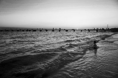 People on beach against sky