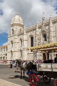 Horse cart on street against jerónimos monastery