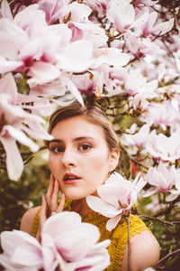 Close-up portrait of woman with pink flowers