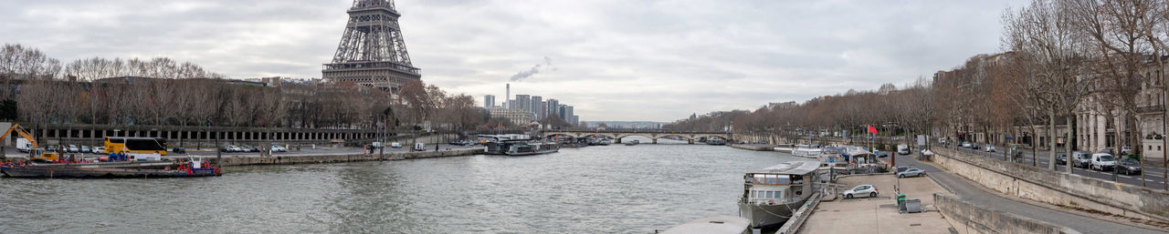 Panoramic view of buildings against cloudy sky