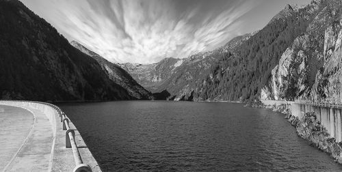 Scenic view of river amidst mountains against sky