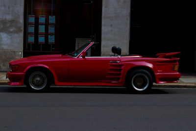 Red toy car on road in city