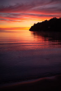 Scenic view of sea against romantic sky at sunset