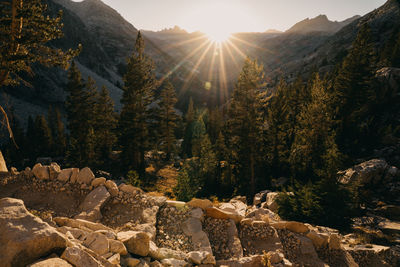 Scenic view of mountains against bright sun