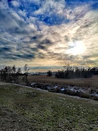 Scenic view of field against sky during sunset