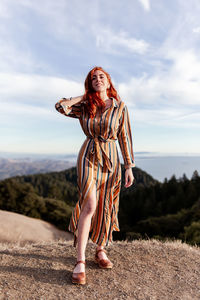 Full length of woman standing against the sky