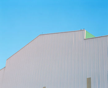 Low angle view of building against clear blue sky