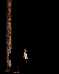 Low angle view of illuminated lights over black background