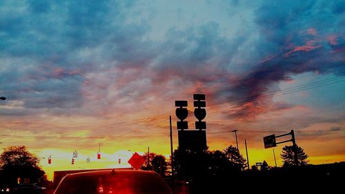 High section of silhouette built structures against scenic sky