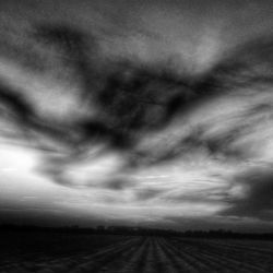 Scenic view of landscape against cloudy sky