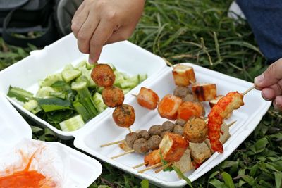 Close-up of man preparing food in plate