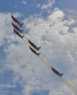 Low angle view of airshow against sky