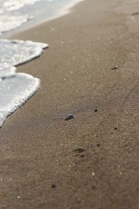 High angle view of footprints on sand at beach