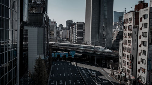 High angle view of street amidst buildings against sky