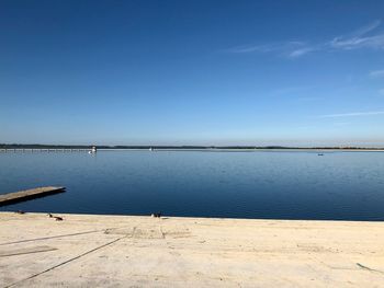 Scenic view of sea against clear blue sky