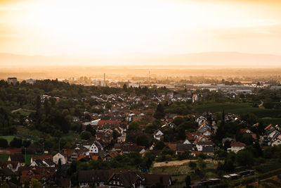 Aerial view of townscape against sky at sunset
