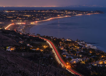 High angle view of illuminated buildings in city at night