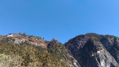 Scenic view of mountains against clear blue sky